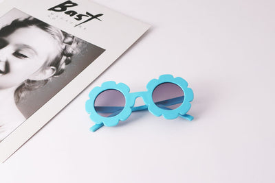Light blue flower-shaped sunglasses with dark lenses, featuring a playful design and plastic frame. - Image 6