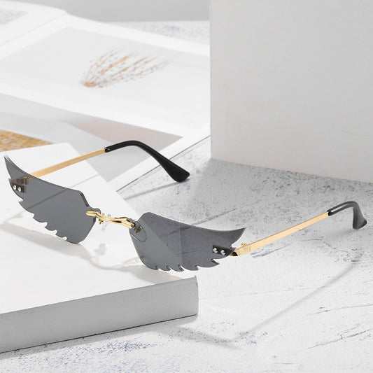 Red angel wings sunglasses with gold metal arms and black earpieces, featuring a unique rimless design. - Image 2