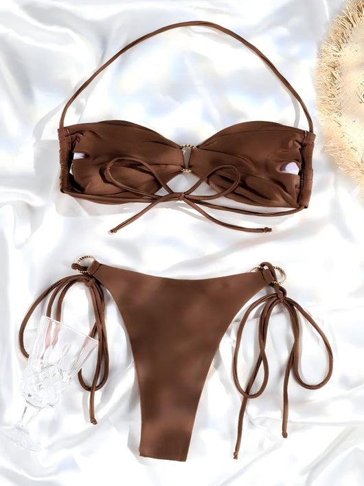 Women's brown lace-up halter bikini suit with ruched top and gold-tone ring details, modeled outdoors. - Image 11