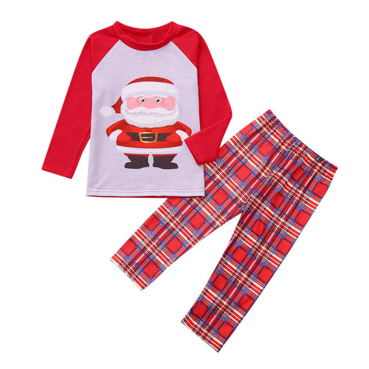Family of five wearing matching red and grey Christmas pajamas with Santa Claus print tops and red plaid pants.