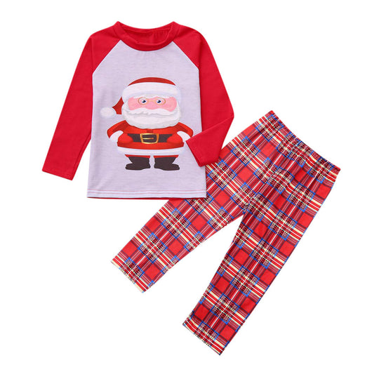 Family of five wearing matching red and grey Christmas pajamas with Santa Claus print tops and red plaid pants.