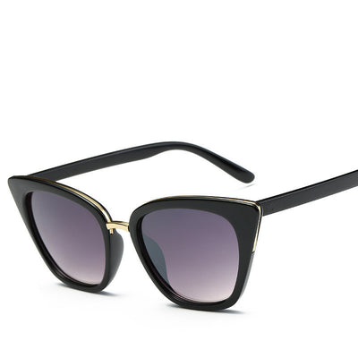 Black cat-eye sunglasses for women with gradient grey lenses and subtle gold-tone metal accents on the frame. - Image 5