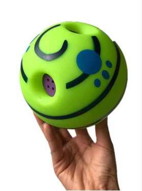 Wobble Wag Giggle dog sound ball, white with green stripes, in blue packaging highlighting glow-in-the-dark feature.