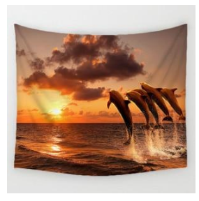Boho print tapestry featuring four dolphins leaping from the ocean against a vibrant orange and yellow sunset.