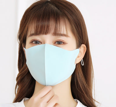 Woman wearing a light gray ice silk face mask with ear loops, suitable for summer and spring. - Image 12