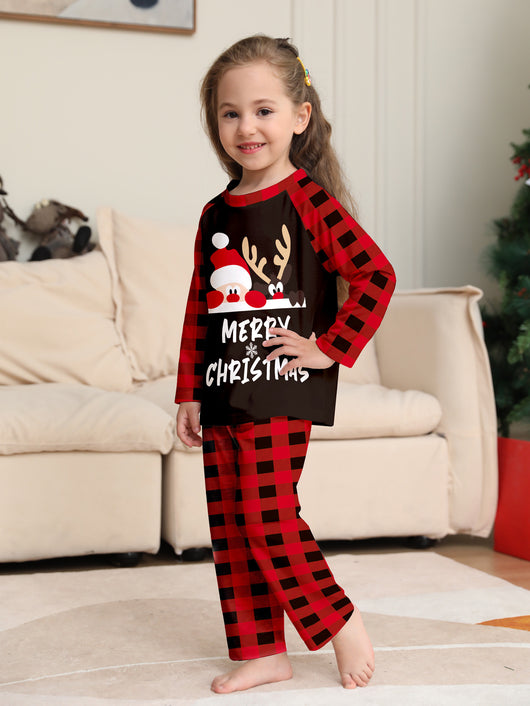 Family of four wearing matching red and black buffalo plaid Christmas pajamas with reindeer graphic. - Image 8
