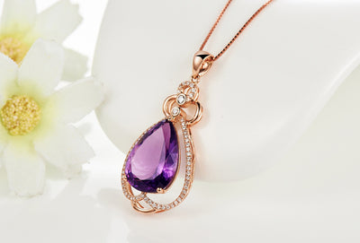 Rose gold necklace with a teardrop purple gemstone pendant and matching dangle earrings. - Image 23