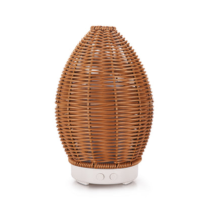 Hollow rattan aroma diffuser with an egg-shaped woven brown exterior and a light wood-grain base. - Image 9