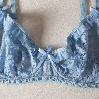 Light blue lace bralette and thong lingerie set with bow details and ruffle trim, displayed on a light surface. - Image 20
