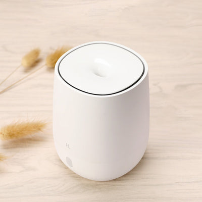 White mini aromatherapy machine with a minimalist design, featuring a top mist outlet and a single control button. - Image 5