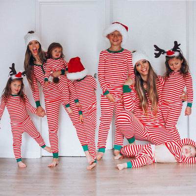 Family of six wearing matching red and white striped long-sleeved pajamas with green cuffs and festive hats. - Image 3