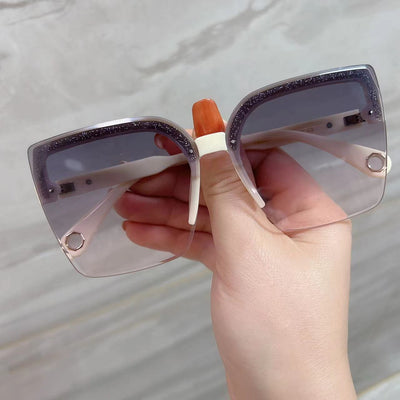 Brown rimless square sunglasses with gradient grey-pink lenses and cream temples with gold-tone accents.