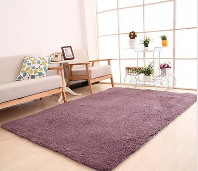 Fluffy purple rectangular area rug on a light wood floor in a modern living room with a sofa and plant stand. - Image 8