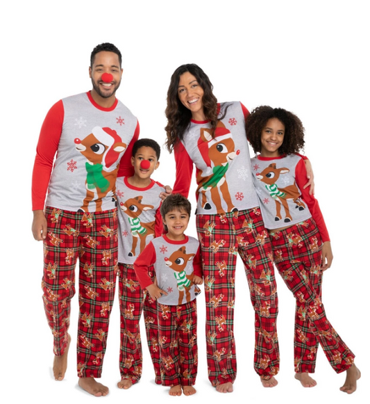 Family of five wearing matching Christmas pajamas with Rudolph the Red-Nosed Reindeer tops and red plaid pants.