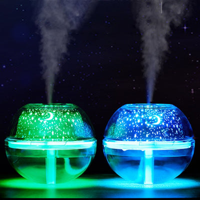 Silver and clear spherical essential oil diffuser with a starry night LED projector, featuring moon and star patterns. - Image 3