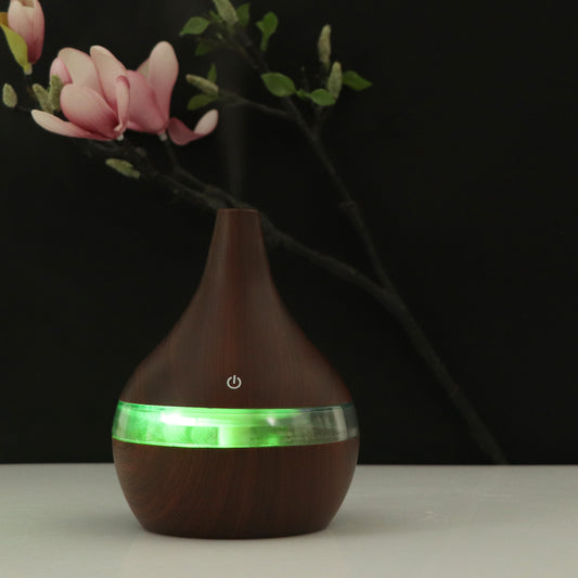 Dark wood grain USB mini tip air purifier and humidifier with a teardrop shape and a silver band. - Image 2