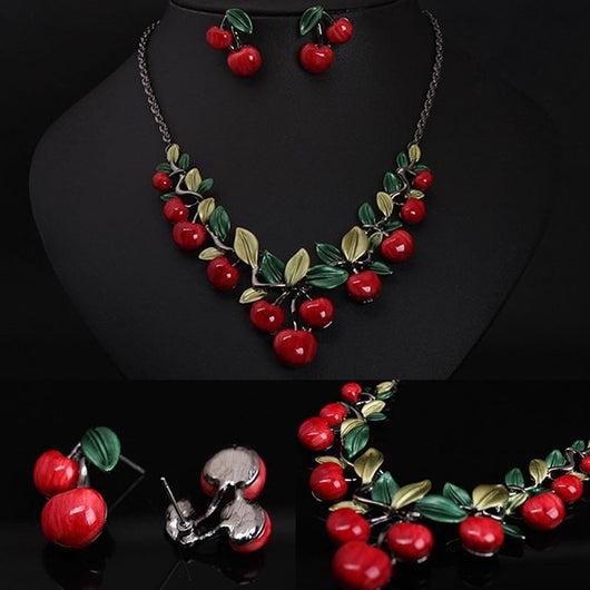 Cherry necklace and earring set featuring red enamel cherries and green leaves on a dark chain, displayed on a black bust. - Image 7