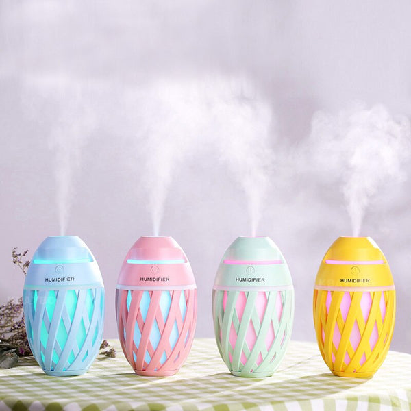 Light green football-shaped humidifier with a decorative lattice pattern and a power button on top.