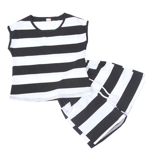 Mother and daughter in matching black and white striped short-sleeved tops and shorts, standing outdoors. - Image 8