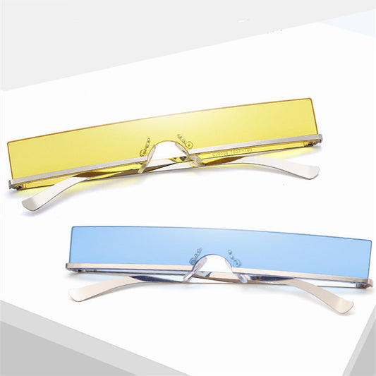 Frameless rectangular sunglasses with dark lenses and silver-colored metal temples, featuring an avant-garde style.