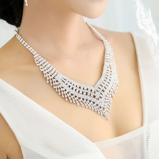 Sparkling rhinestone necklace and dangle earrings set. Large V-shaped bib necklace with claw chain design and matching long drop earrings. - Image 2