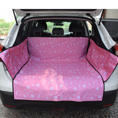 Blue waterproof pet car mat with white paw print and bone patterns installed in the trunk of a white SUV. - Image 5