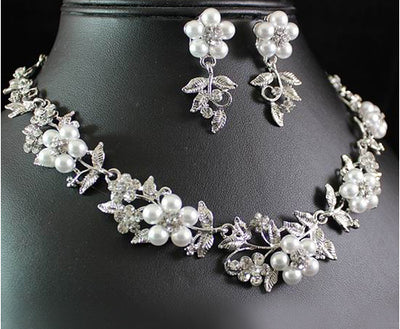 Silver-tone bridal necklace and earring set with white pearls and clear rhinestones in a floral leaf design. - Image 3