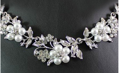 Silver-tone bridal necklace and earring set with white pearls and clear rhinestones in a floral leaf design. - Image 4