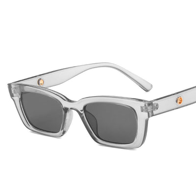 Transparent gray frame sunglasses with dark gray rectangular lenses and small gold accents on the temples. - Image 23