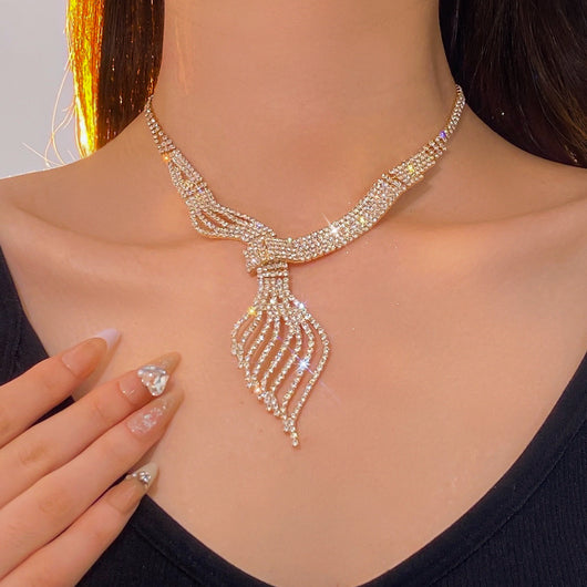 Gold-tone rhinestone necklace and matching dangle earrings set. The necklace features a multi-strand, leaf-like design. - Image 16