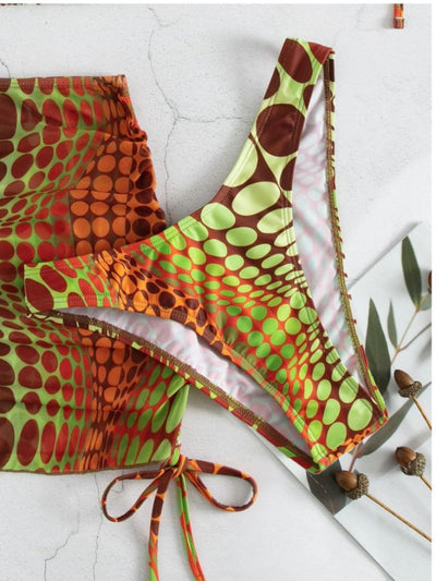 Women's printed split bikini swimsuit set with halter top, high-cut bottom, sarong skirt, and headscarf in green, brown, and orange optical dot pattern. - Image 10