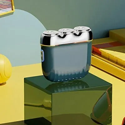 Orange mini electric shaver with three silver floating cutter heads, a blue power button, on a translucent orange block. - Image 8