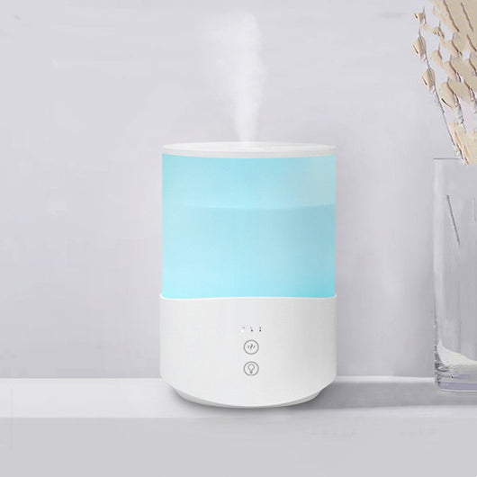 White cylindrical household humidifier with a translucent top section glowing blue, featuring two control buttons. - Image 6