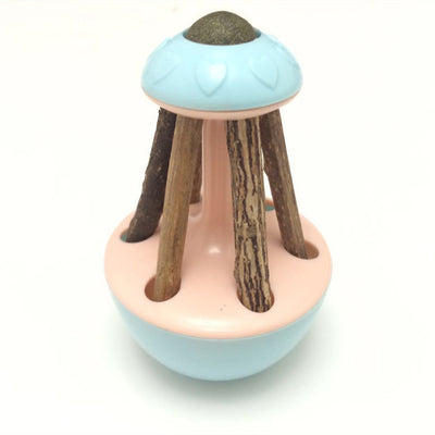 Pink tumbler cat toy with a green catnip ball on top and several natural wooden sticks for chewing. - Image 5