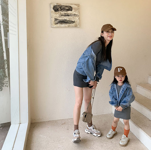 Woman and child in matching outfits: light blue denim jackets and dark gray knitted mini dresses, with baseball caps and sneakers. - Image 11