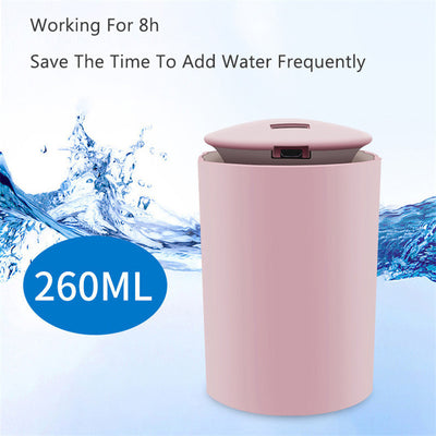White cylindrical USB mini humidifier with blue LED light, emitting a fine mist, suitable for home or car. - Image 3