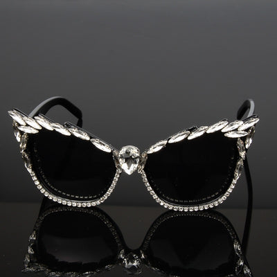 Black cat-eye sunglasses with clear rhinestones along the frames and a large teardrop rhinestone at the bridge. - Image 2
