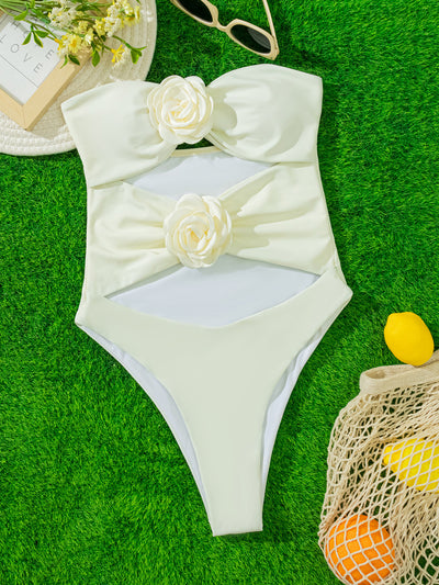 White strapless one-piece swimsuit with 3D flower details and side cut-outs, worn by a woman by an infinity pool. - Image 14