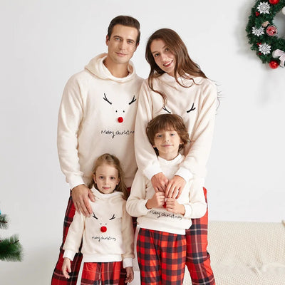 Family of four wearing matching cream fleece reindeer pajamas with red plaid pants, posing for a Christmas photo. - Image 20