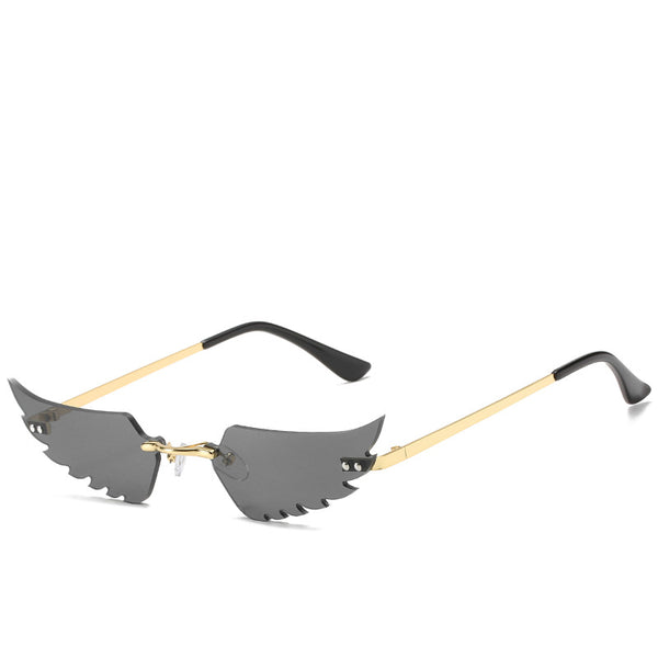 Purple wing-shaped rimless sunglasses with gold-colored metal arms and black ear tips on a white background. - Image 13