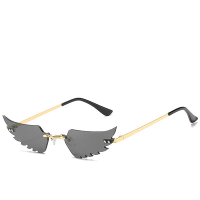 Purple wing-shaped rimless sunglasses with gold-colored metal arms and black ear tips on a white background. - Image 13