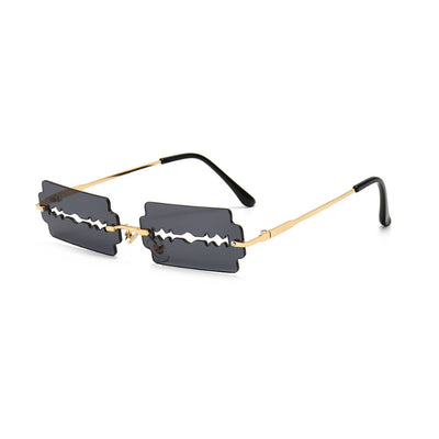 Orange razor blade shaped rimless sunglasses with gold metal frames and black ear tips on a white background. - Image 4