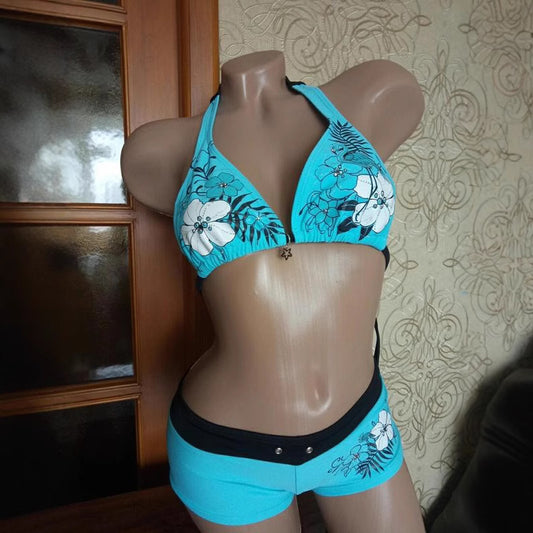 Black halter bikini suit with boy short bottoms, featuring pink and blue floral and flamingo patterns. - Image 2
