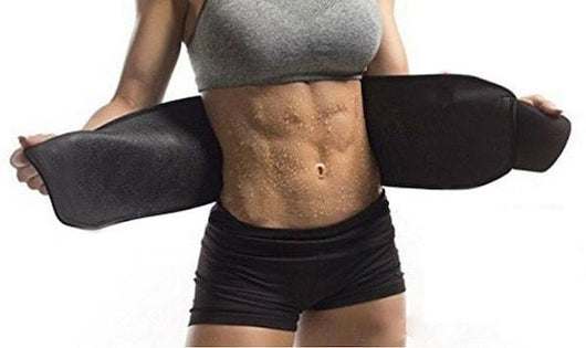 Person wearing a black neoprene abdominal waist trainer, with visible sweat on their toned midsection.