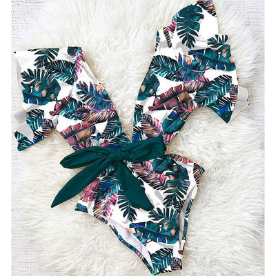 Coral one-piece swimsuit with deep V-neck, ruffled sleeves, and tie-front waist, featuring pink and teal floral print. - Image 17