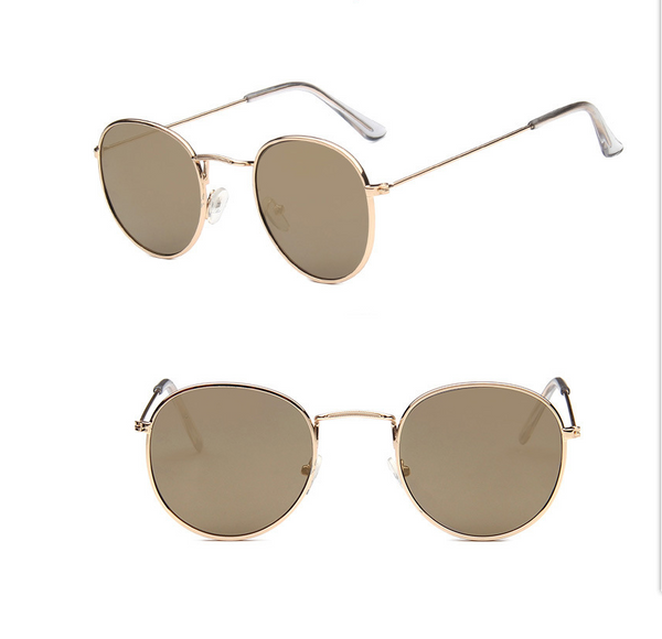 Two pairs of round gold-frame sunglasses, one with mirrored orange lenses and one with solid red lenses.