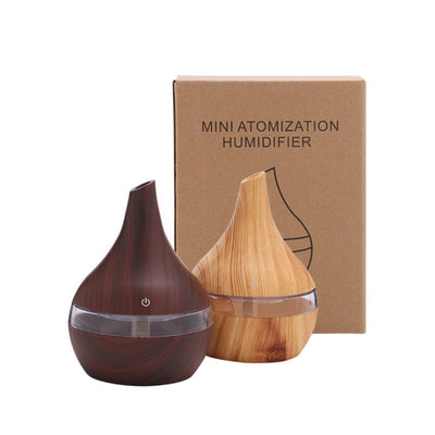 Teardrop-shaped humidifier with light wood grain finish and clear water tank, featuring a power button icon. - Image 7