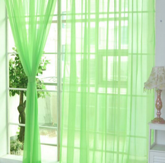 Close-up of a solid red sheer tulle curtain hanging in front of a window, allowing light to filter through. - Image 15