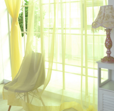 Close-up of a solid red sheer tulle curtain hanging in front of a window, allowing light to filter through. - Image 16