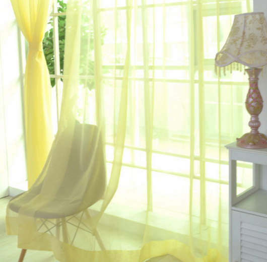 Close-up of a solid red sheer tulle curtain hanging in front of a window, allowing light to filter through. - Image 16